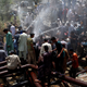 Residents cluster around the spray from a leaking water pipeline in Karachi.